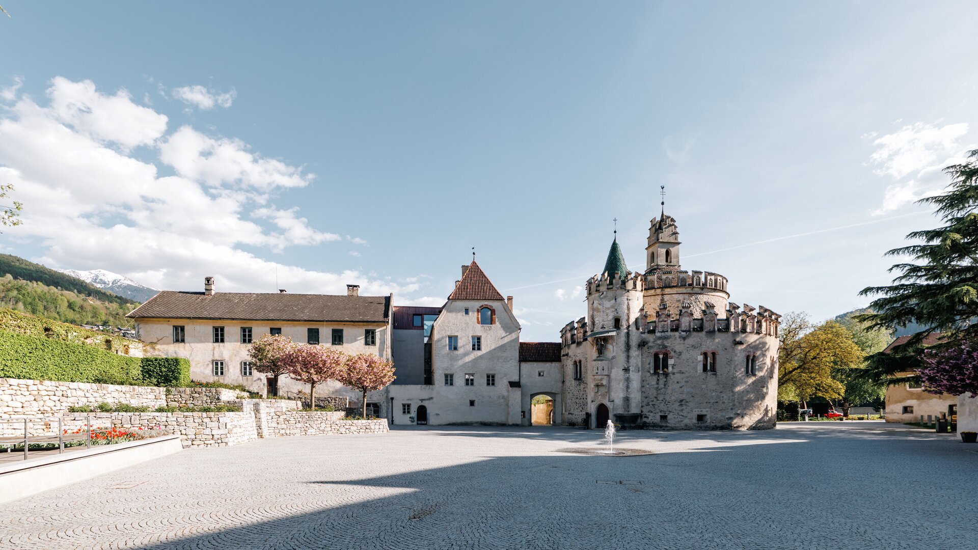 Sunny historic square with castle-like buildings in Brixen Südtirol