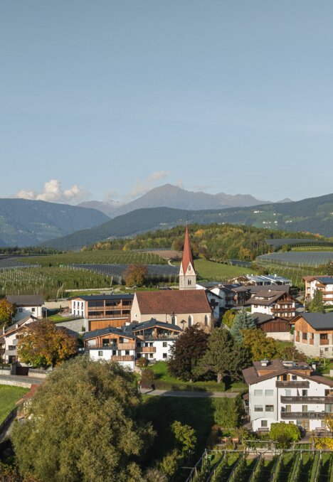 Village with church, vineyards and mountains in Brixen Südtirol