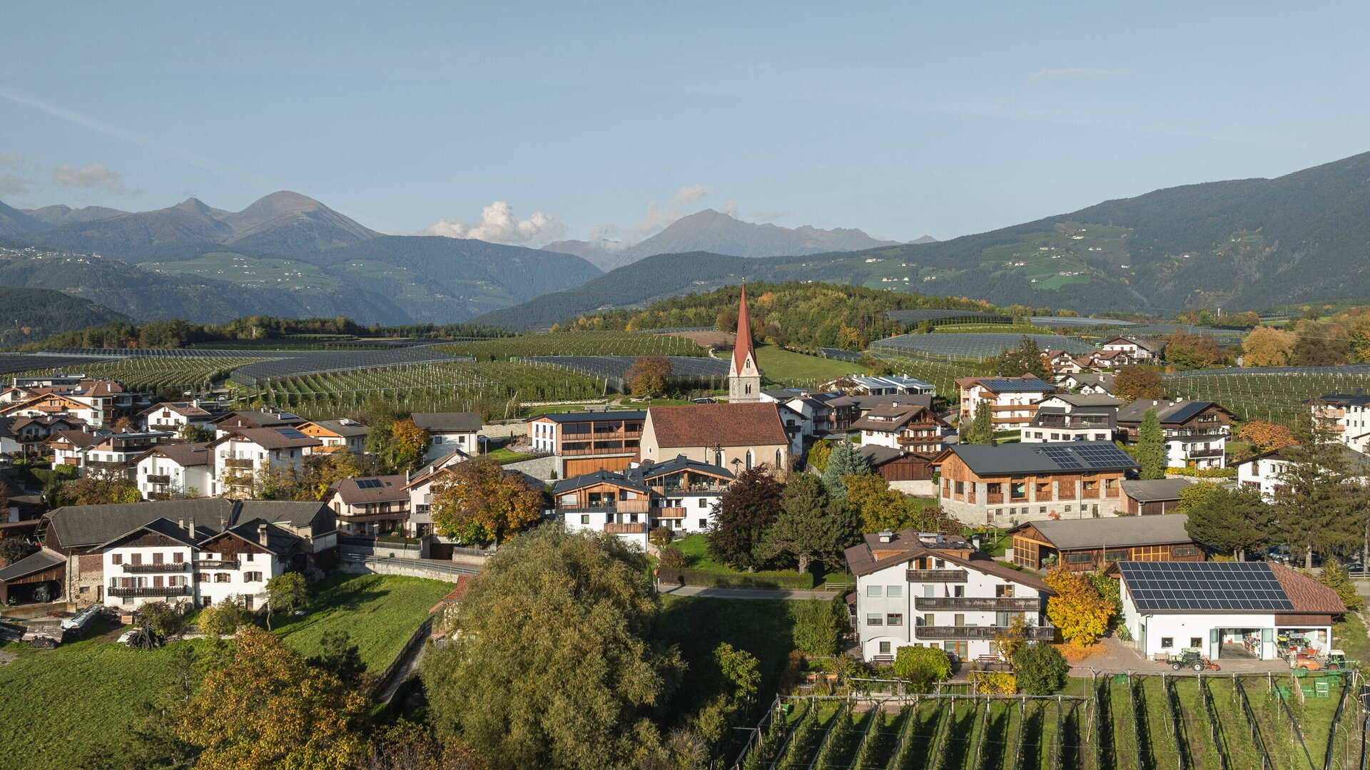 Village with church, vineyards and mountains in Brixen Südtirol