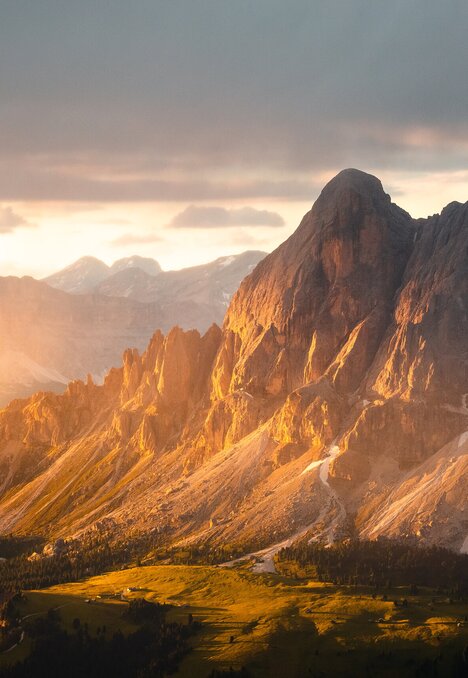 Alba sulle spettacolari cime dolomitiche sopra una valle alpina verde vicino a Brixen Südtirol.